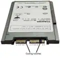 A 1.8-inch micro SATA hard drive with numbered data and power pins on the connector