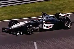 Häkkinen driving a silver-and-black McLaren