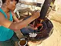Extracting sesame oil by a bullock driven wooden press, Myanmar