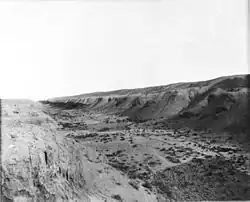A black and white photo of a dry riverbed