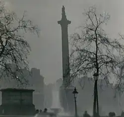 black-and-white photograph of a tall monument and its surroundings partially obscured by haze