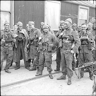 A group of 15 men in uniform carrying weapons