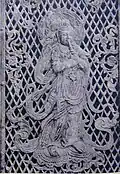 Relief of a Krishna previous Bodhisattva playing a flute on the temple's 8th century Octagonal Lantern.