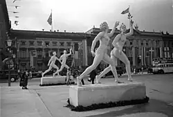 Two large nude classical statues outdoors