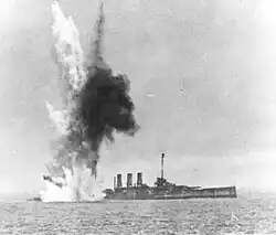 The ship already settling by the stern, another bomb explodes underwater