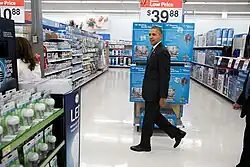 President Barack Obama walks through the aisles at Walmart