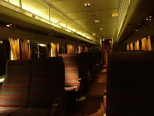 Rows of reclining seats inside a railcar