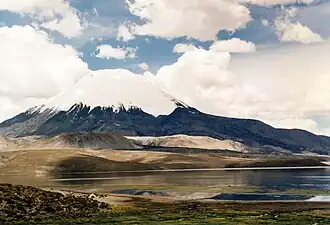 The white lava domes and a black lava flow are visible above the lake