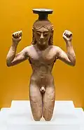 Ancient Greek perfume bottle in shape of an athlete binding a victory ribbon around his head; circa 540s BC; Ancient Agora Museum (Athens)