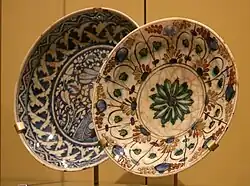 Two ceramic plates with painted floral designs