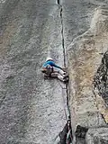 A climber doing the laybacking technique