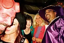A man (far right) dressed as a pimp and women dressed as "hoes" at a Halloween party, 2000