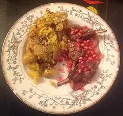 Turkish lamb chops with candied figs and herbed mashed potatoes, garnished with pomegranate