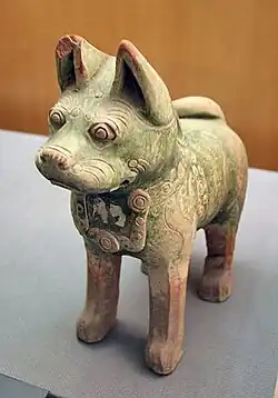 A dog figurine found in a Han tomb wearing a decorative dog collar, indicating their domestication as pets.[183] Dog figurines are a common archaeological find in Han tombs,[184] while it is also known from written sources that the emperor's imperial parks had kennels for keeping hunting dogs.[185]
