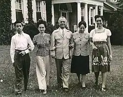 Tinted photo of a smiling Quezon, Aurora and their three children