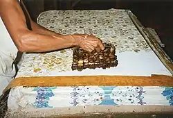 Hand-stamping batik using a cap in Java