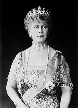 Mary in tiara and gown wearing a choker necklace and a string of diamonds