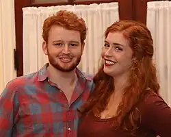 Two siblings posing for the camera.