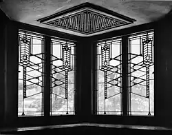 Geometric patterns on four windows as seen from inside the house