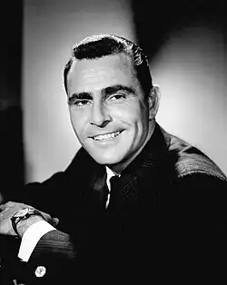 Dark-haired man holding a lit cigarette