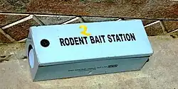 Blue box labeled "rodent bait station"