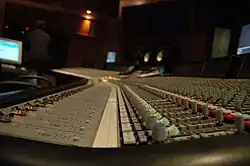 A recording console inside a studio.