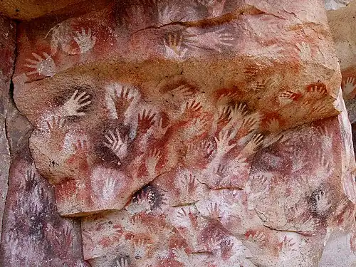 Stencils of hands at the Cueva de las Manos, Argentina, dated to either 7,300 BC to 700 AD or 13,000–9,000 BP