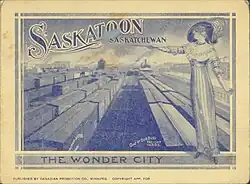 a woman standing over a busy train yard in Saskatoon with the words "Saskatoon, the Wonder City"