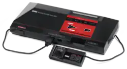 A video game console with numerous video game boxes behind it.
