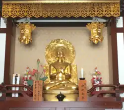 A Buddhist altar in Kawasaki, Japan showing a devotional mantra inscribed in Siddham to Shakyamuni Buddha with Japanese pronunciation guide