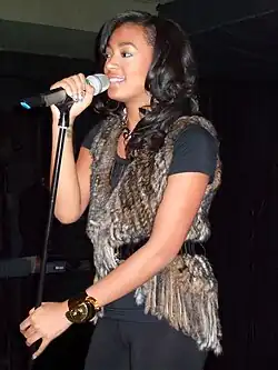 Solange performing into a microphone