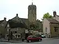 Street scene showing houses with octagonal church tower behind