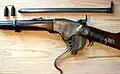 The Spencer repeating rifle with the breech open. Before the breechblock carrier can "roll" downward, the breechblock must fall vertically to clear the receiver.