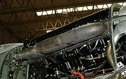 The right side of an uncowled, installed aircraft engine, with details of the exhaust system