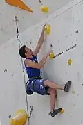 A climber doing the backstepping technique