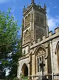 Stone building with arched windows and square tower.