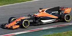 Vandoorne driving an orange-and-black McLaren MCL32