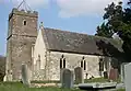 Stone building with square tower.