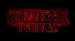 "Stranger Things" text written in red neon on a black background