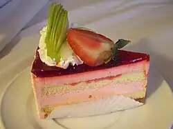 A slice of strawberry cake with garnishing of strawberry