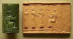 Sumerian cylinder seal and impression, dated c. 2100 BC, of Ḫašḫamer, ensi (governor) of Iškun-Sin c. 2100 BC. The seated figure is probably king Ur-Nammu, bestowing the governorship on Ḫašḫamer, who is led before him by Lamma (protective goddess).[367]