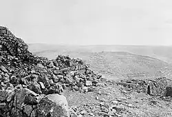 View of rocky ground and cultivated terraces in landscape extending to the horizon