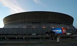 Domed stadium in shadow, ground view looking up
