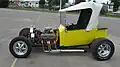 Ford T-bucket based hot rod. Also features dropped tube axle, transverse front leaf spring, and front disc brakes.