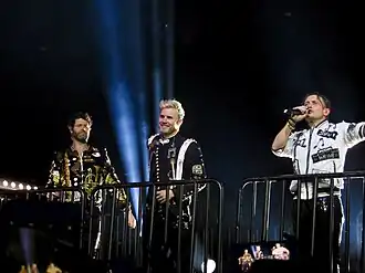 Take That performing in 2017. From left to right: Howard Donald, Gary Barlow, Mark Owen