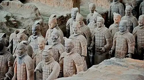 A group of the Terracotta Warriors standing in an archaeological dig site