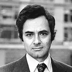Black-and-white photo of a man with dark hair wearing a tie
