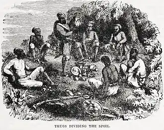 A group of individuals in a forest clearing, gathered around a pile of valuables