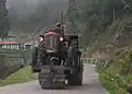 A tractor-driven road roller