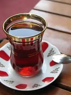 Turkish tea served in a typical small glass and corresponding saucer